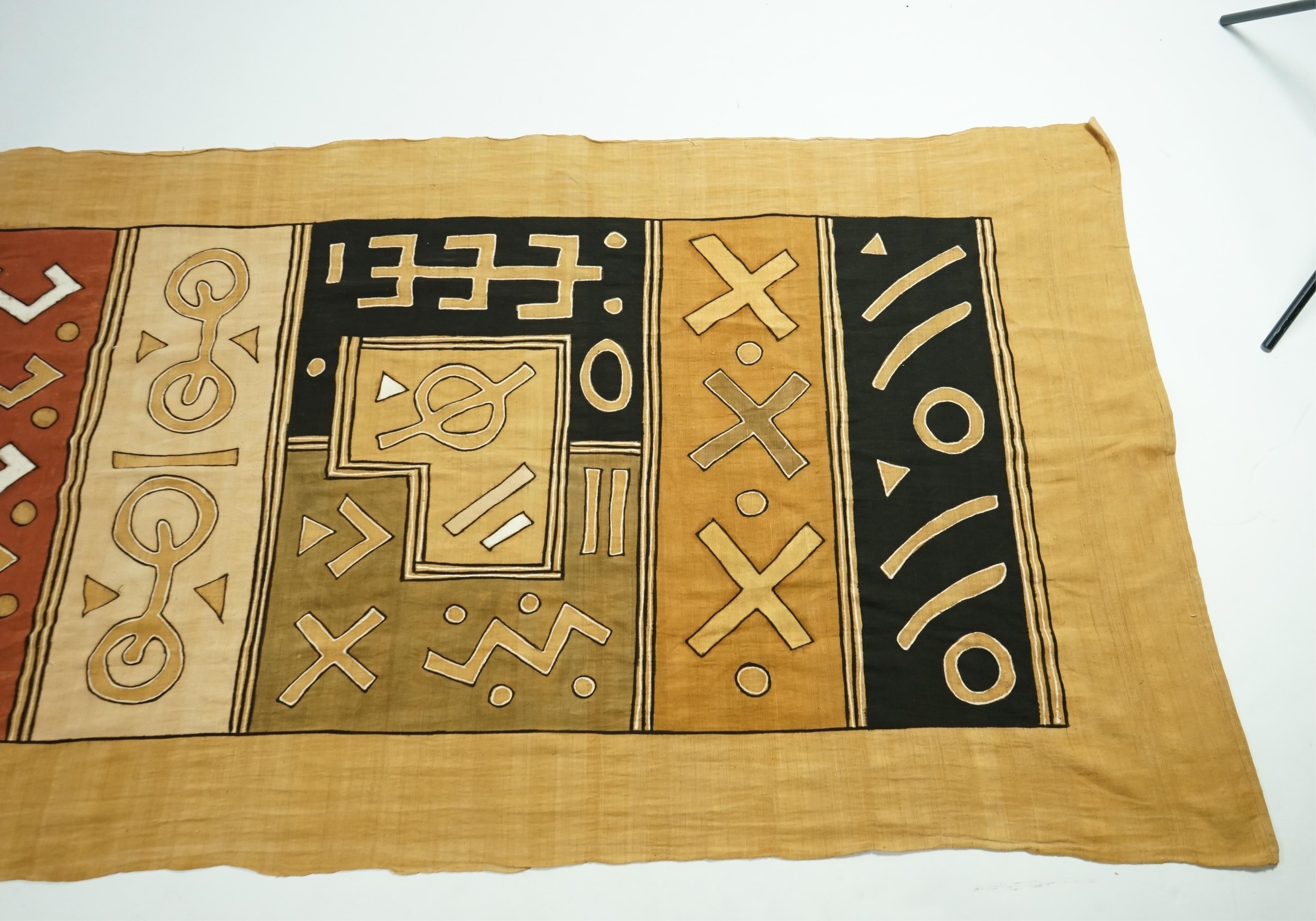 A collection of five 20th century African Congo hand woven and embroidered raffia palm leaf runners and mats, together with a later large printed hanging. 260cm x 138cm. Condition - one smaller mat has a hole in the weav